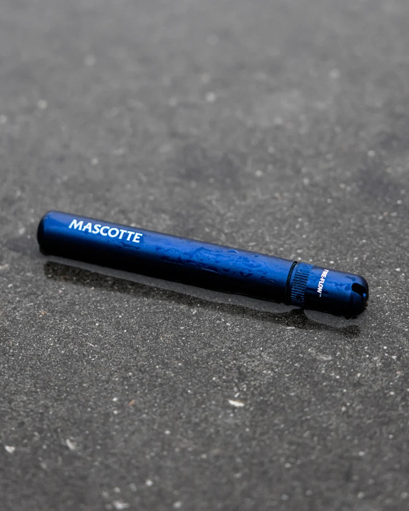 Mascotte JaySafe azul oscuro sobre una superficie gris